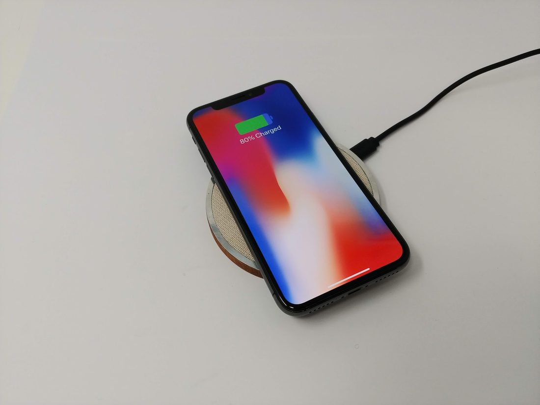 EFD.1 — a wireless charger machined from mahogany, aluminium and linen, with a phone charging on top